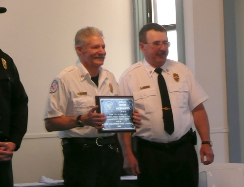 Fire Chief Steve Avgeris (right) honors retiring Assistant Fire Chief Andy Herskind with a commemorative plaque
